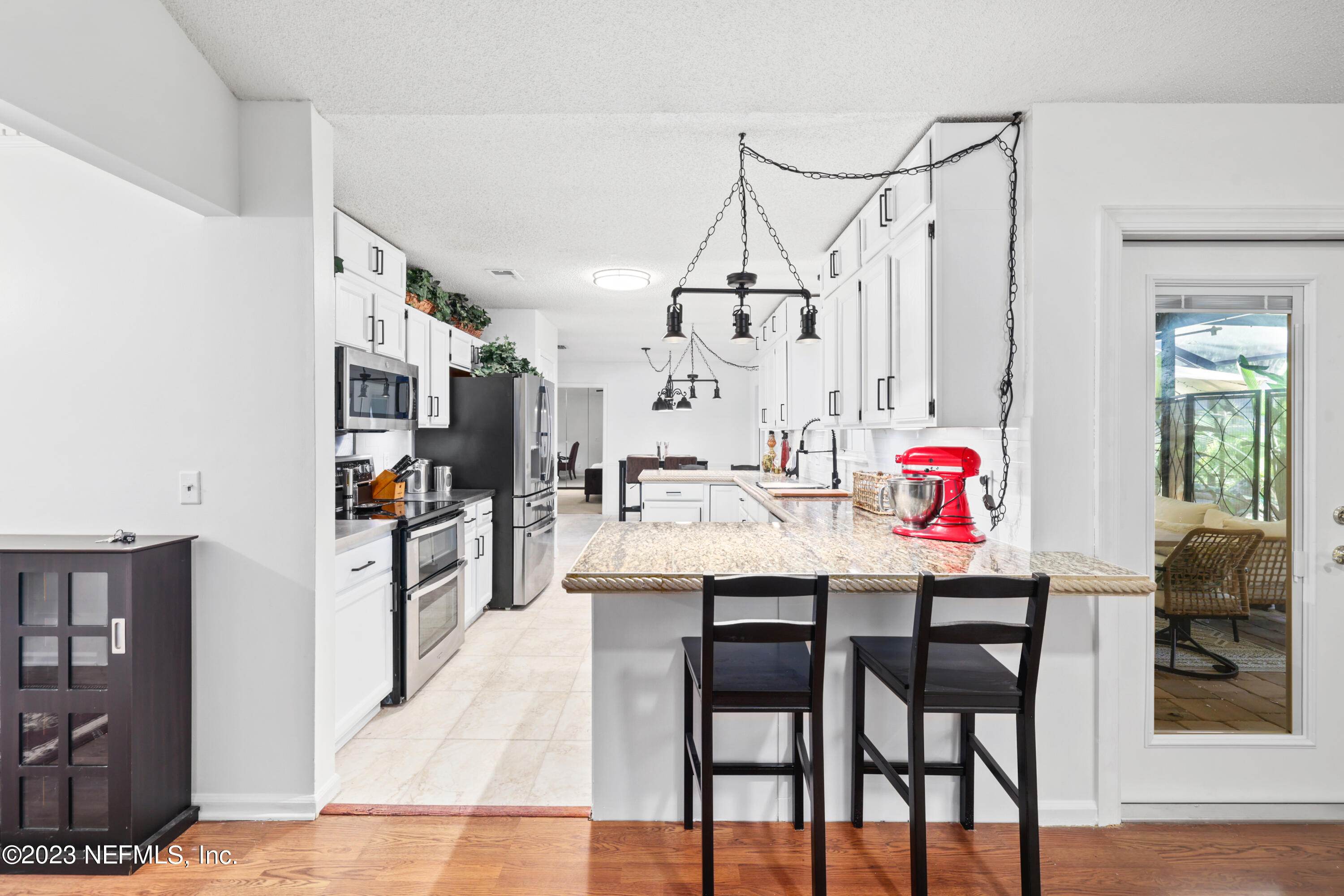 10954 Heathfield Road Jacksonville, FL 32225 - Photo 10 of 42 a dinning area with kitchen island stainless steel appliances wooden floor and cabinets
