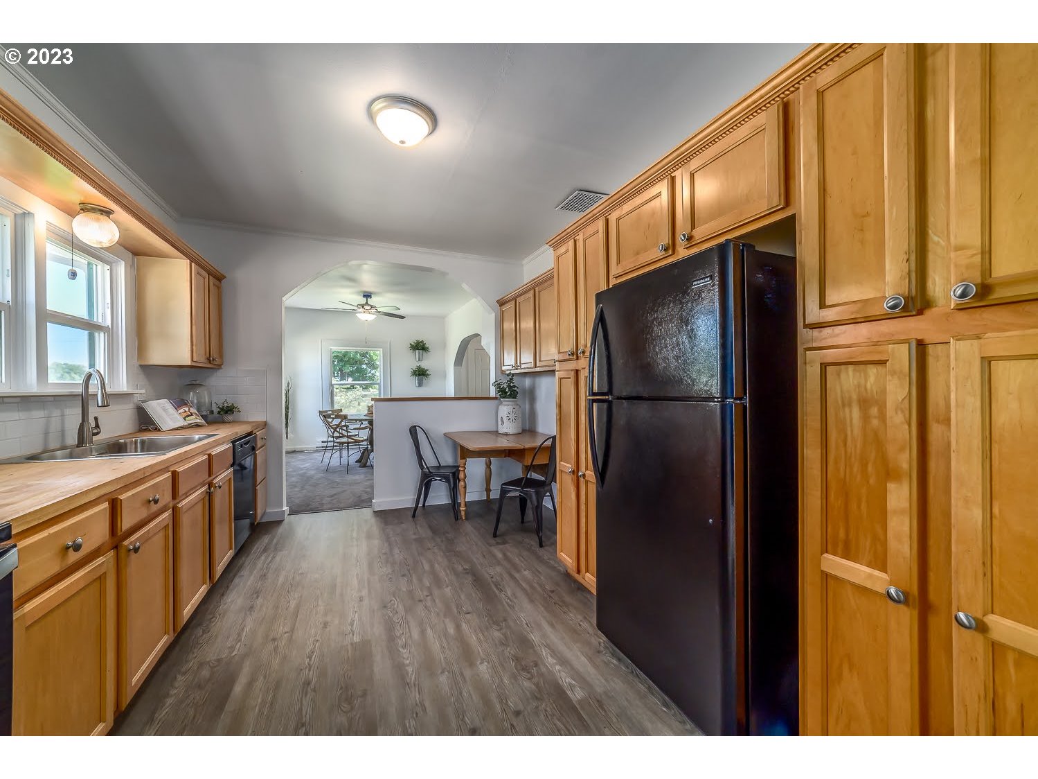 89780 Green Hill Road Eugene, OR 97402 - Photo 19 of 48 a kitchen with stainless steel appliances granite countertop a refrigerator a sink dishwasher and a stove with wooden floor