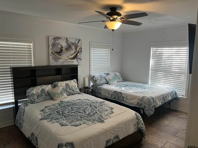 a bedroom with two beds and a chandelier