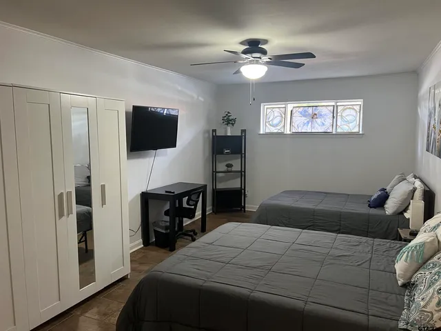 a bedroom with a bed and a flat screen tv