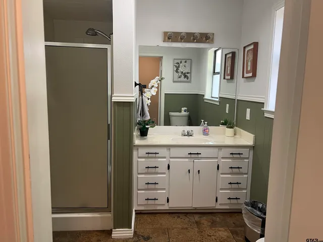 a bathroom with a sink vanity and mirror