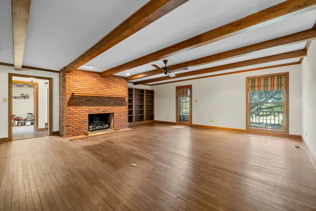 a view of a room with wooden floor and stairs
