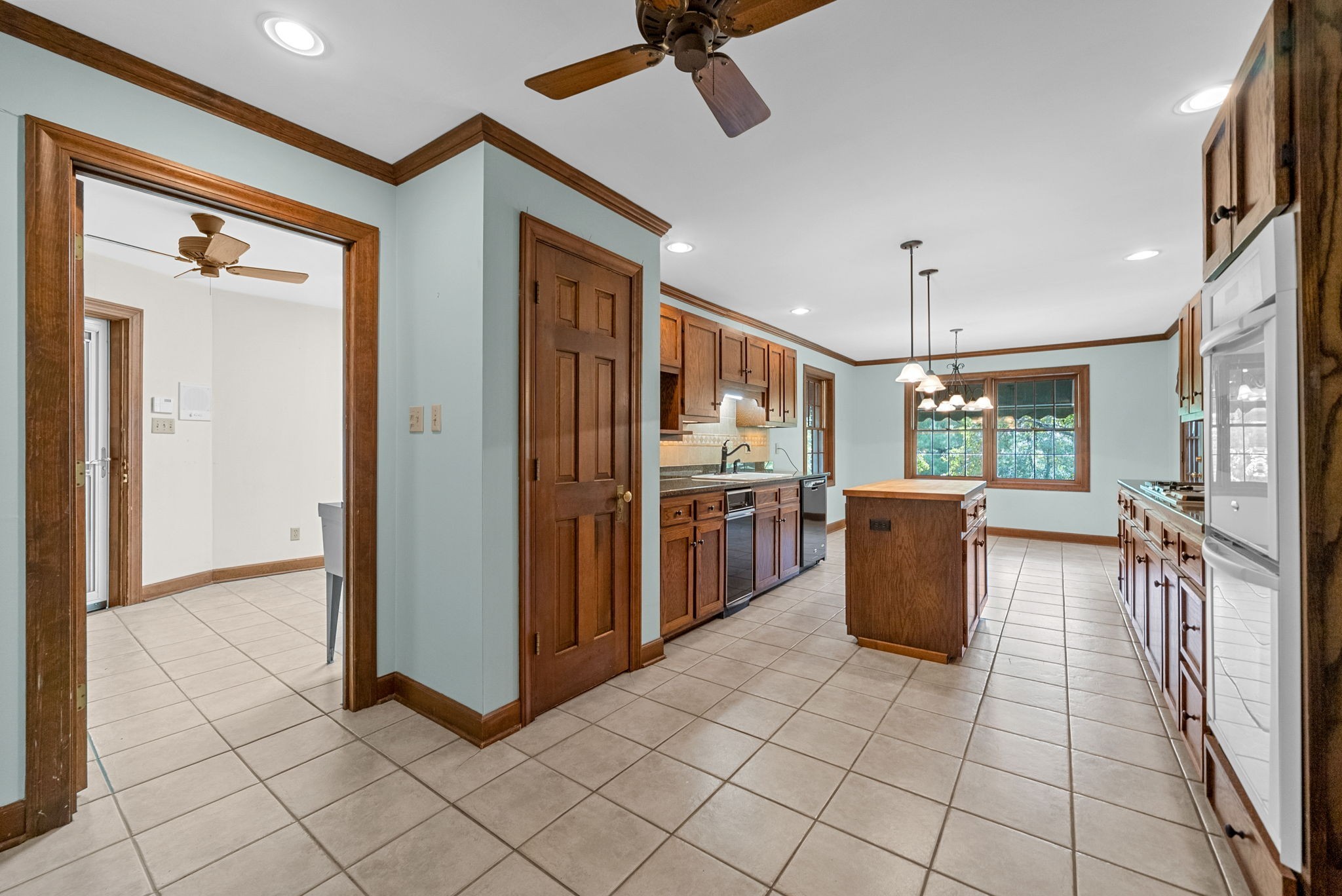 3058 Cox Mill Road Hopkinsville, KY 42240 - Photo 17 of 60 a open kitchen with a refrigerator a stove top oven a sink and a dining table with wooden floor