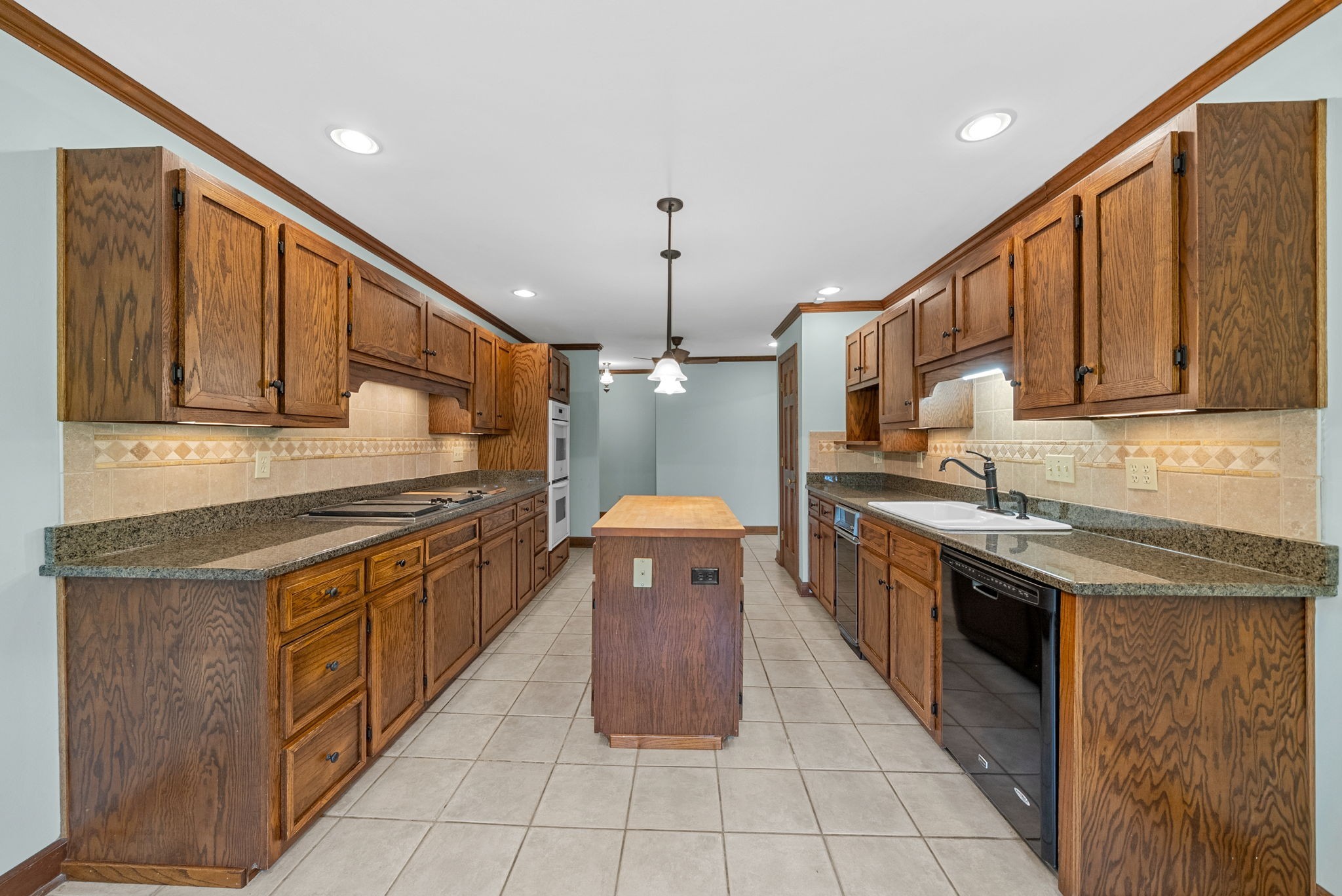 3058 Cox Mill Road Hopkinsville, KY 42240 - Photo 19 of 60 a kitchen with stainless steel appliances granite countertop a stove a sink and a refrigerator
