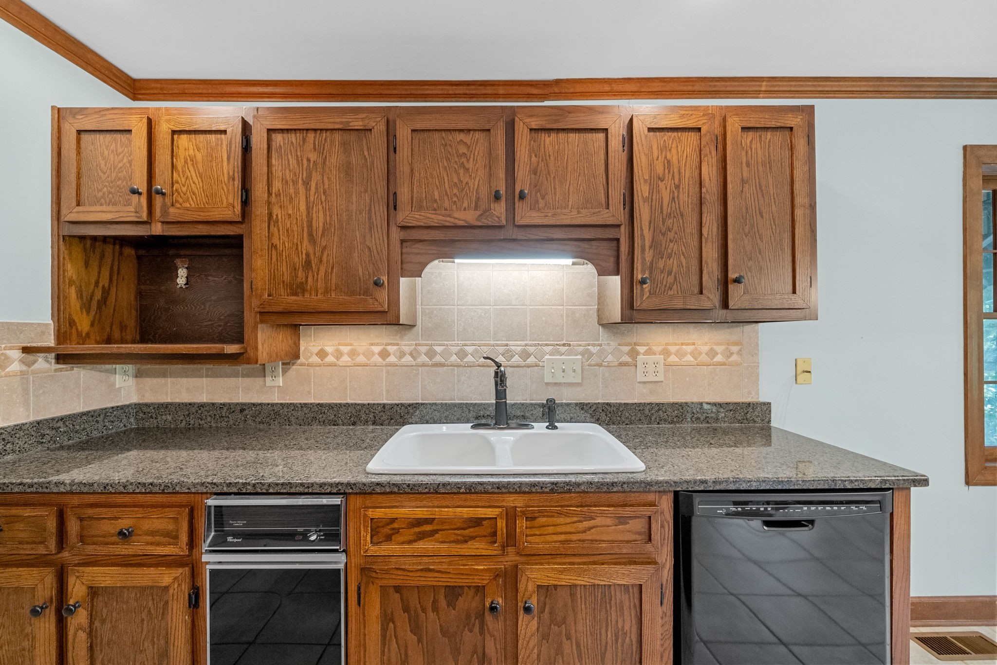 3058 Cox Mill Road Hopkinsville, KY 42240 - Photo 23 of 60 a kitchen with granite countertop a sink stove and cabinets