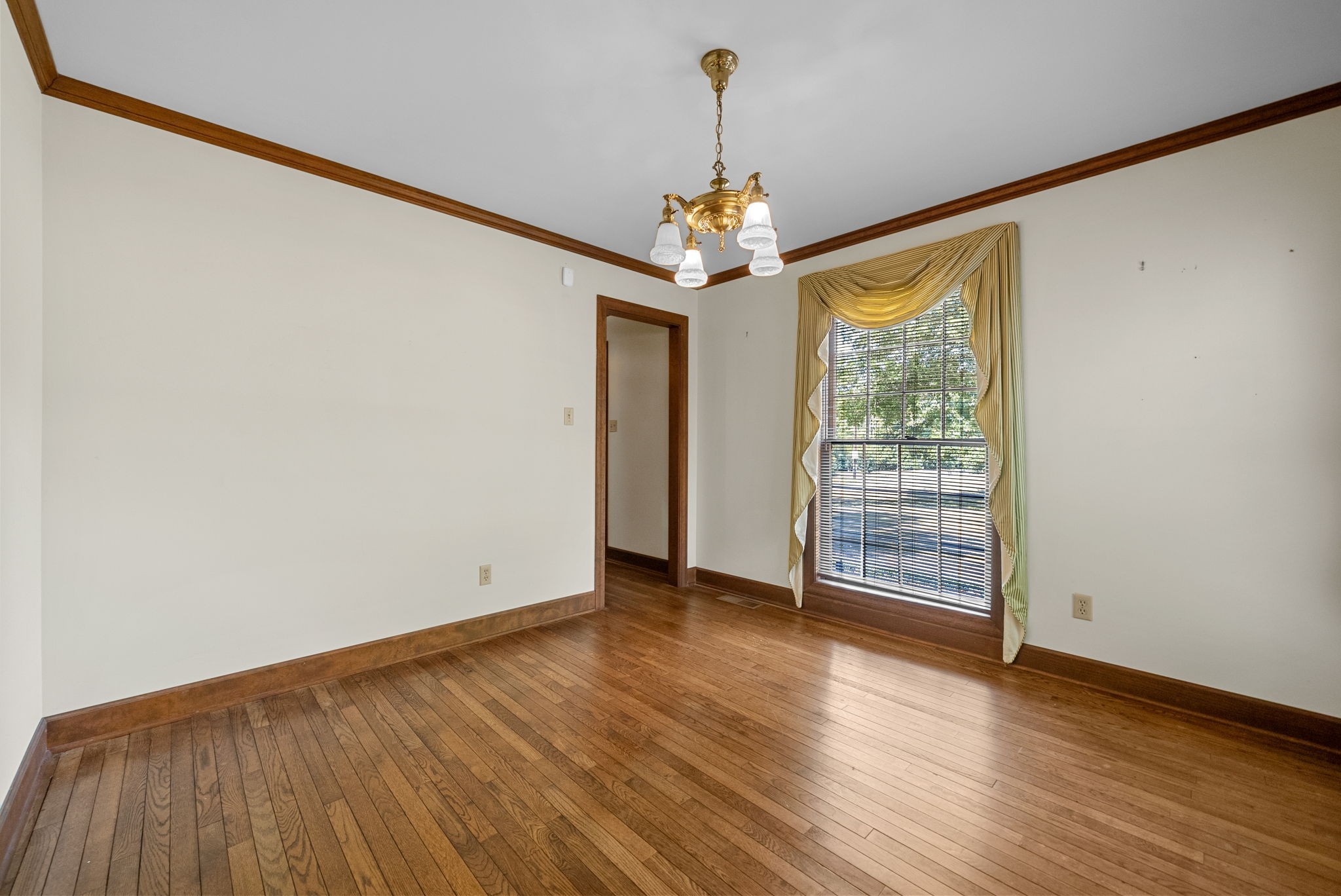 3058 Cox Mill Road Hopkinsville, KY 42240 - Photo 24 of 60 a view of an empty room with wooden floor and a window