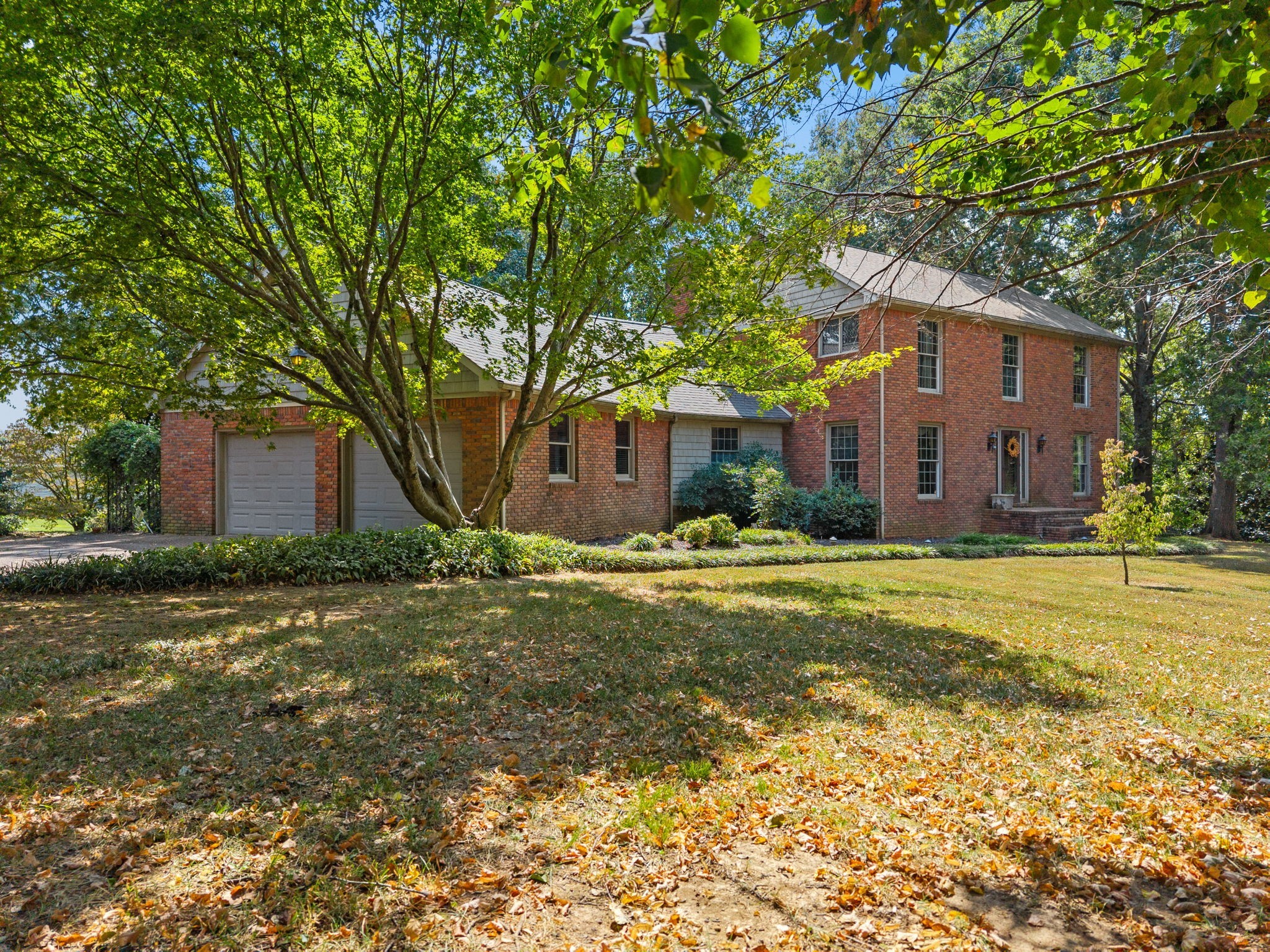 3058 Cox Mill Road Hopkinsville, KY 42240 - Photo 3 of 60 a front view of brick house with a yard and large trees