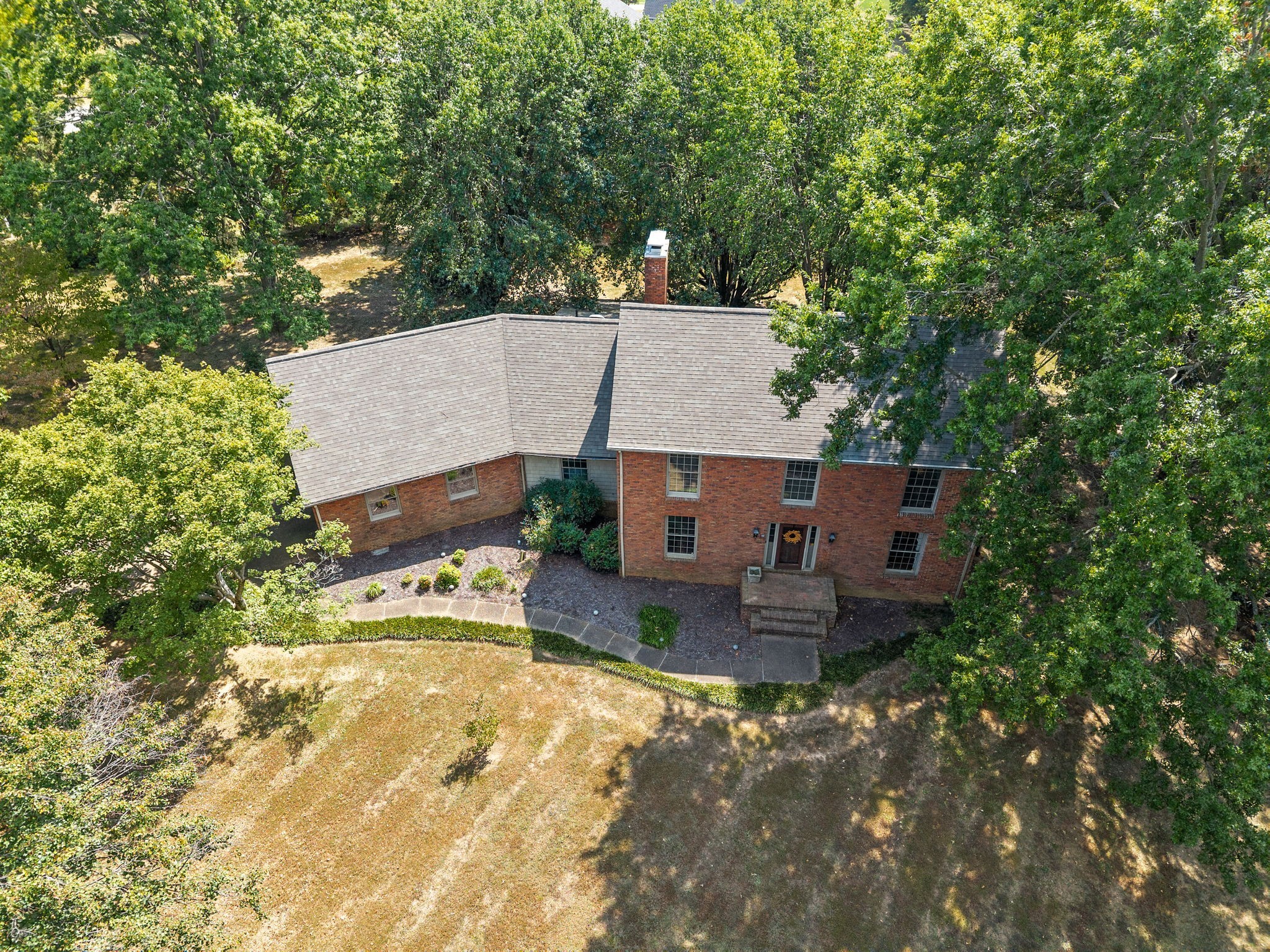 3058 Cox Mill Road Hopkinsville, KY 42240 - Photo 5 of 60 an aerial view of a house with a yard and large trees