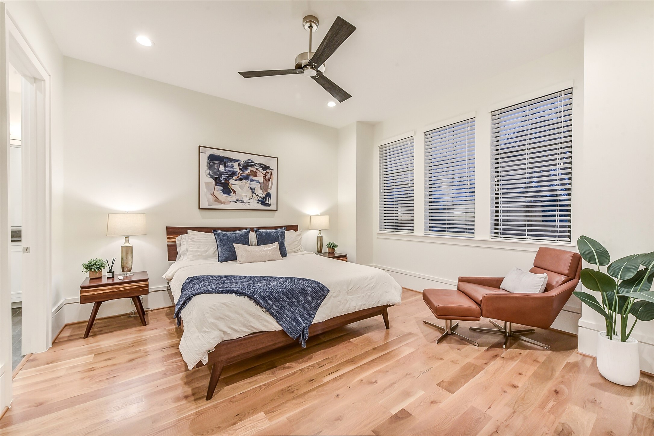 2205 Goldsmith Street Houston, TX 77030 - Photo 20 of 44 a spacious bedroom with a bed a couch and a potted plant