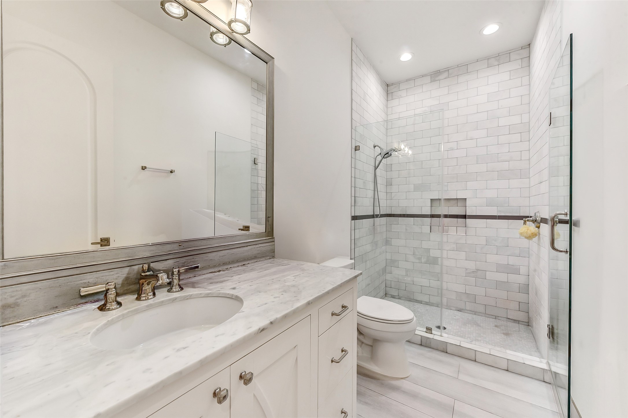 2205 Goldsmith Street Houston, TX 77030 - Photo 23 of 44 a bathroom with a granite countertop sink a toilet a mirror and shower