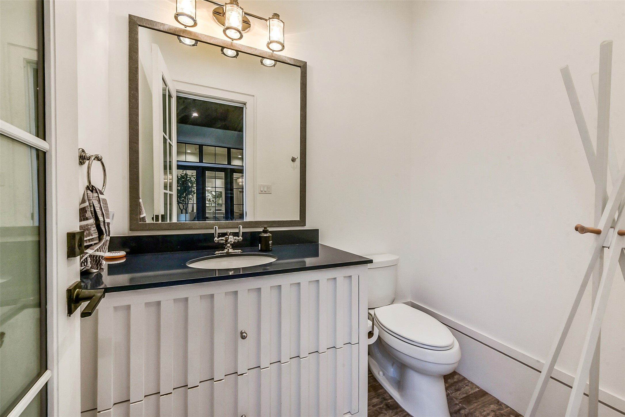 2205 Goldsmith Street Houston, TX 77030 - Photo 29 of 44 a bathroom with a granite countertop sink a toilet and a mirror