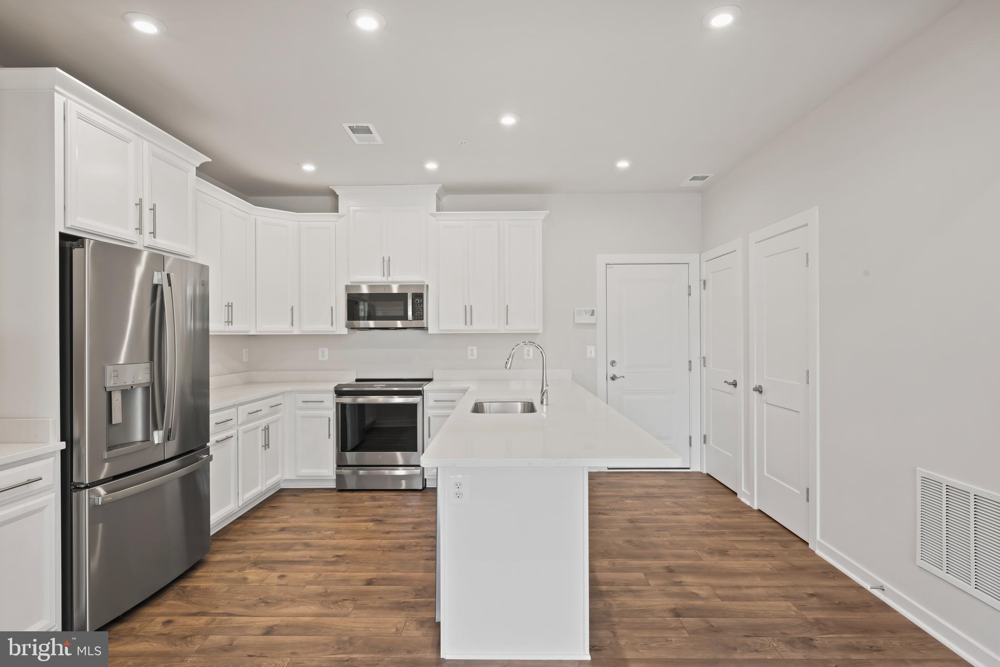 20364 Newfoundland Square Ashburn, VA 20147 - Photo 11 of 68 a large kitchen with stainless steel appliances granite countertop a refrigerator oven a stove and a sink