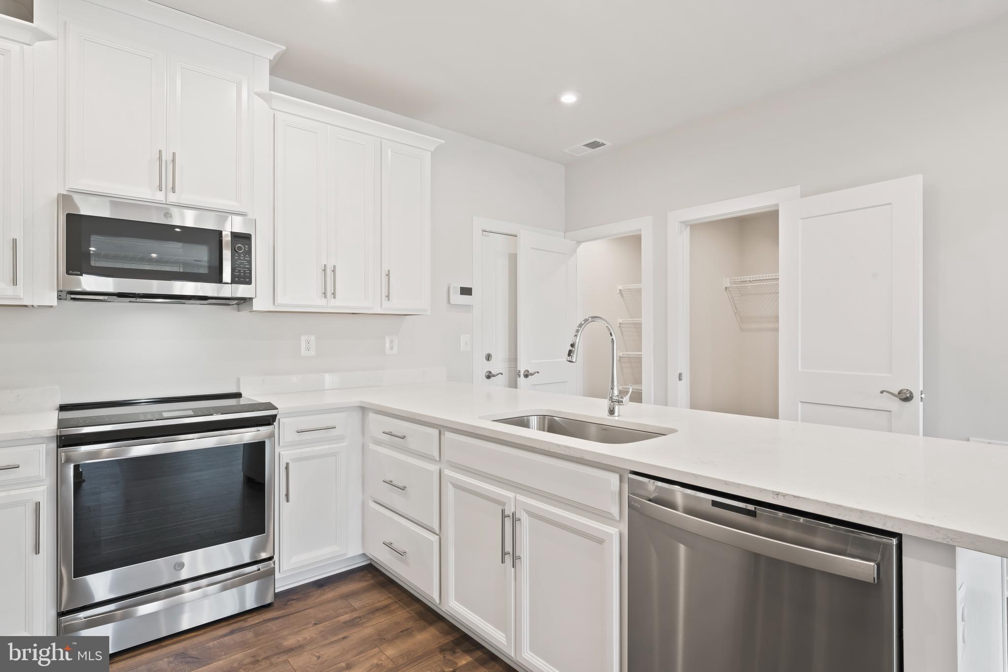 20364 Newfoundland Square Ashburn, VA 20147 - Photo 15 of 68 a kitchen with appliances a sink and cabinets