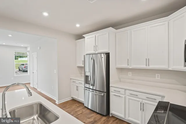 a kitchen with stainless steel appliances a sink and a refrigerator