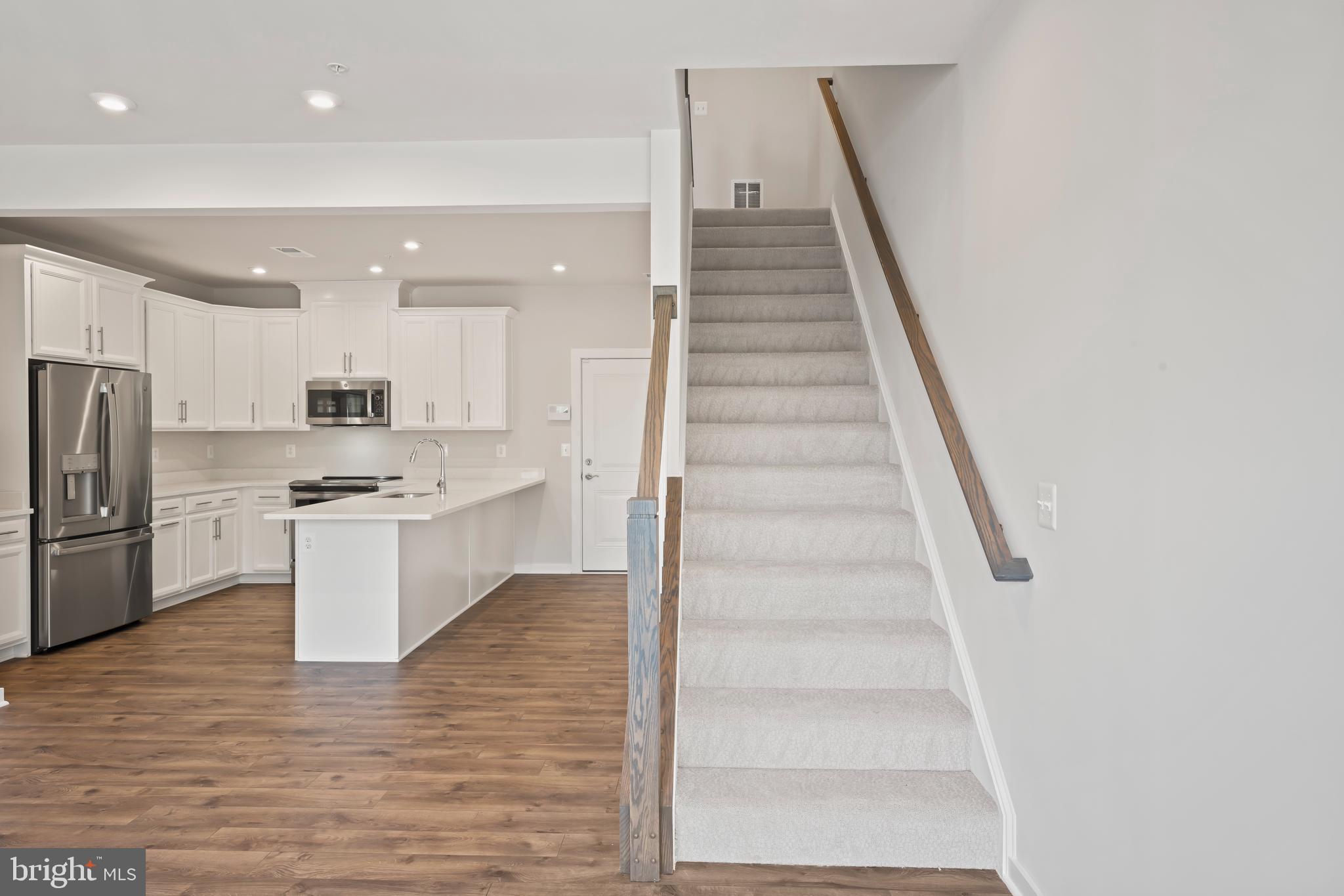 20364 Newfoundland Square Ashburn, VA 20147 - Photo 17 of 68 a kitchen with white cabinets and white appliances