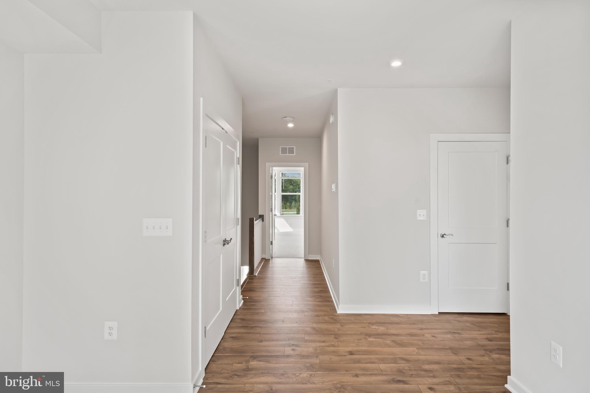 20364 Newfoundland Square Ashburn, VA 20147 - Photo 32 of 68 a view of a hallway with wooden floor