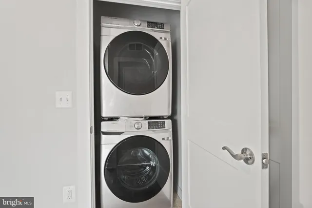 a street sign on a wall next to a road