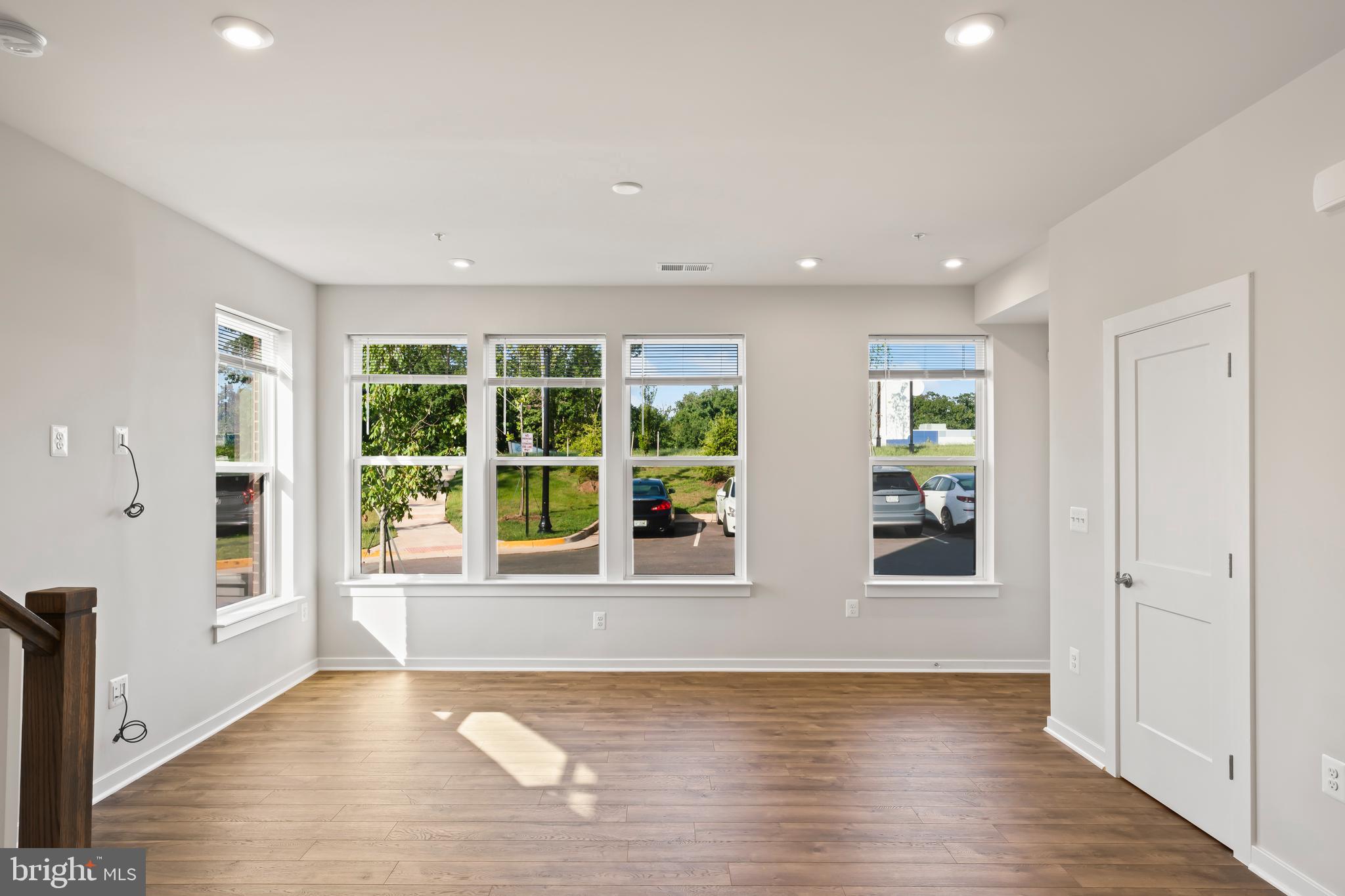 20364 Newfoundland Square Ashburn, VA 20147 - Photo 9 of 68 an empty room with wooden floor and windows