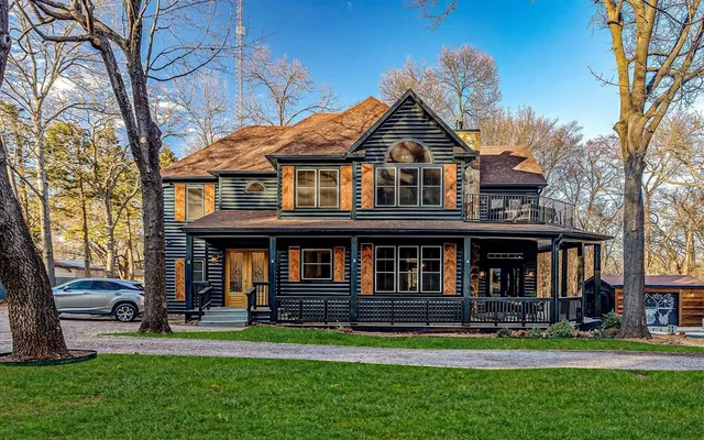 a front view of a house with a yard table and chairs