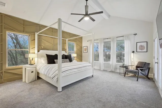 a spacious bedroom with a bed and a window