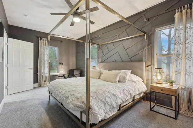 a bedroom with a bed and a chandelier