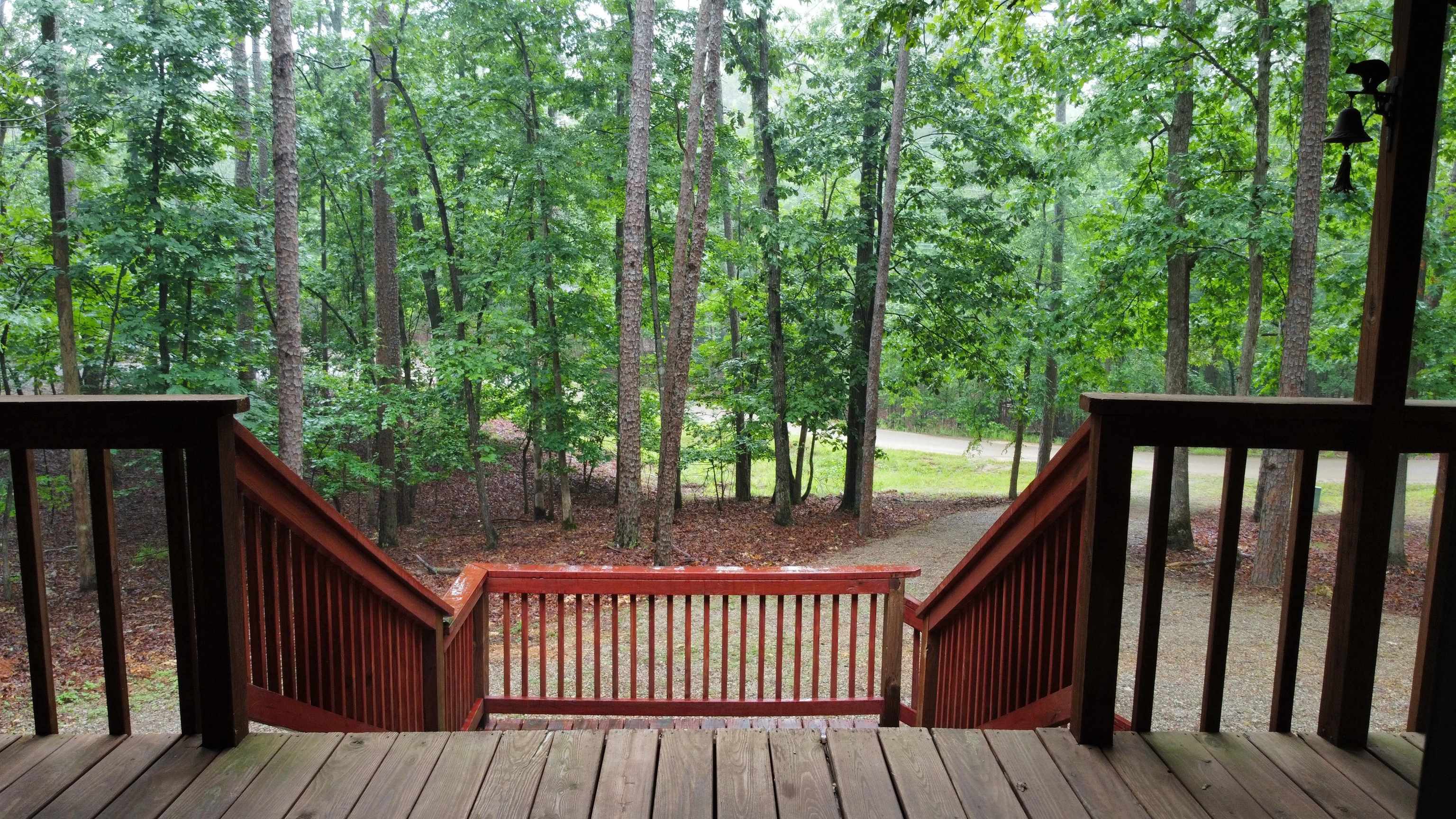 275 Bryson Harbor Road Counce, TN 38326 - Photo 13 of 23 Expansive wooden deck featuring stained railings and a natural tree-lined backdrop