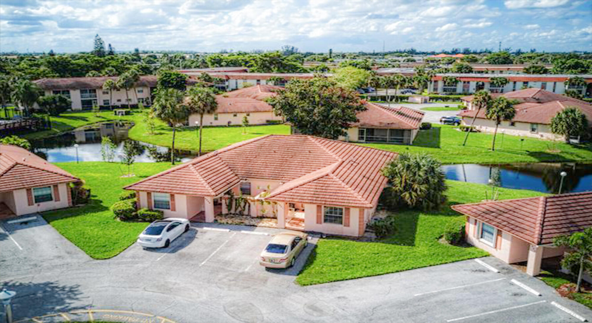 9861 Three Lakes Circle Boca Raton, FL 33428 - Photo 1 of 21 an aerial view of a house with garden space and street view