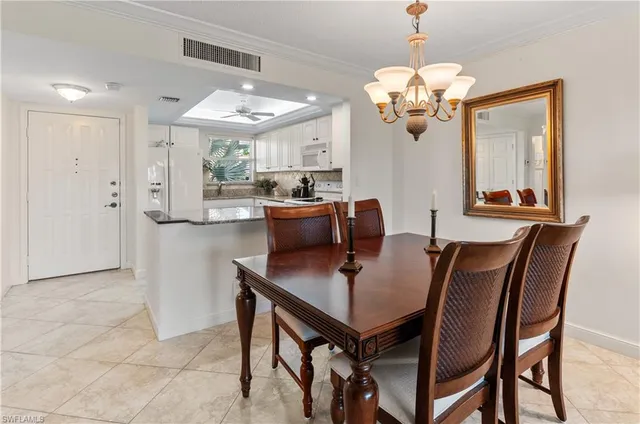 a view of a dining room with furniture and a chandelier