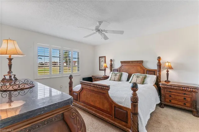 a bedroom with a bed and dresser with window
