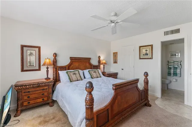 a bed room with a bed and a chandelier