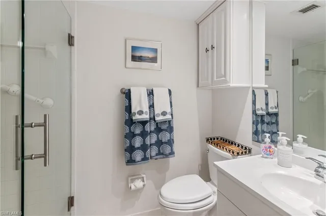 a white toilet sitting next to a bathroom sink
