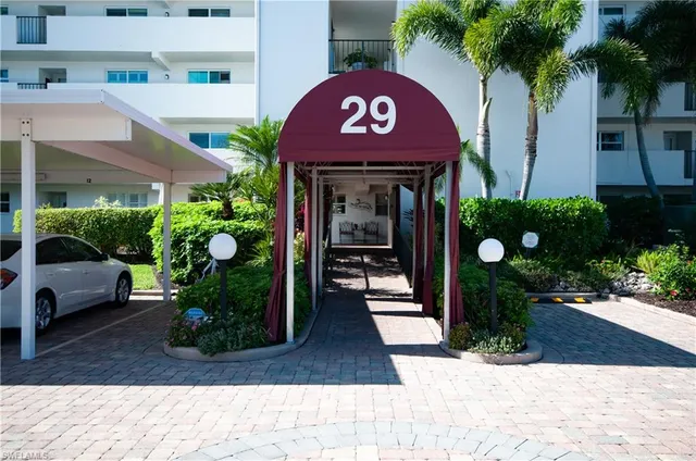 a front view of a building with potted plants