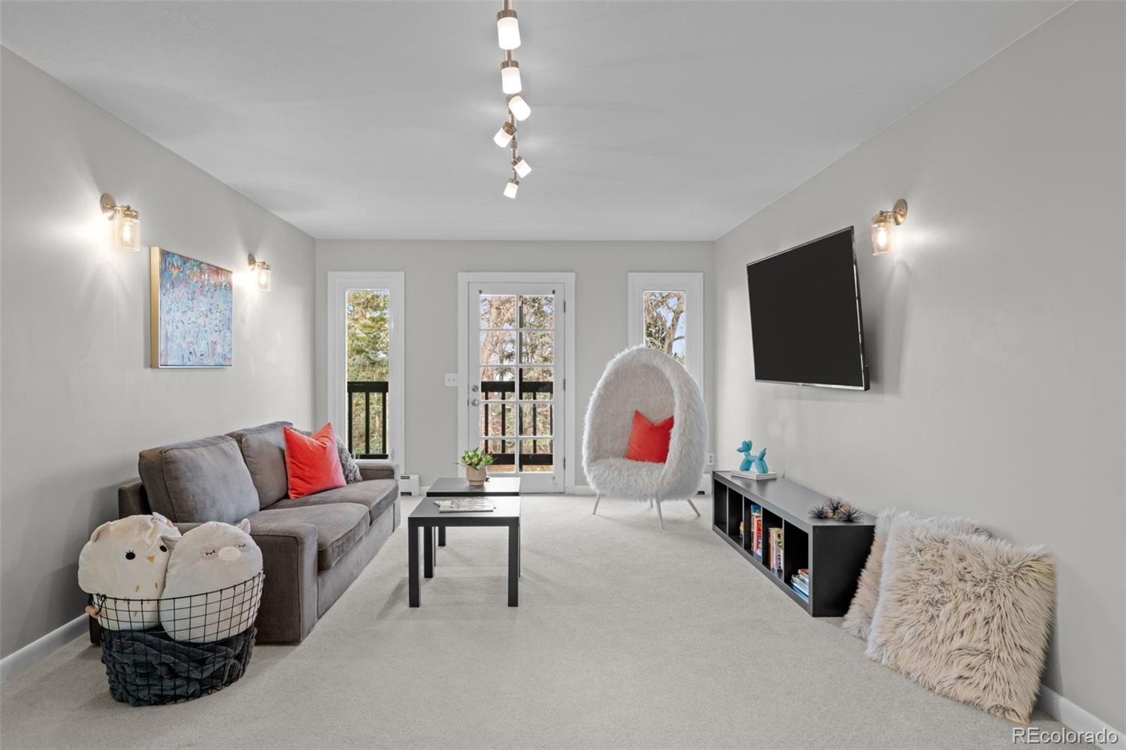 1 Rangeview Drive Wheat Ridge, CO 80215 - Photo 12 of 45 a living room with furniture and a flat screen tv