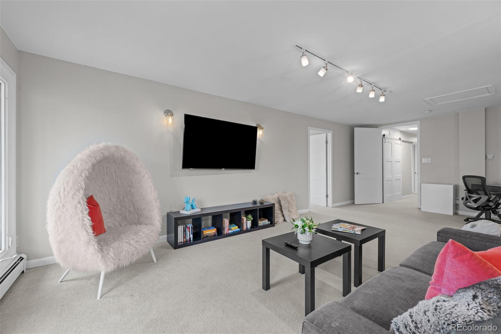 1 Rangeview Drive Wheat Ridge, CO 80215 - Photo 13 of 45 a living room with furniture and a flat screen tv