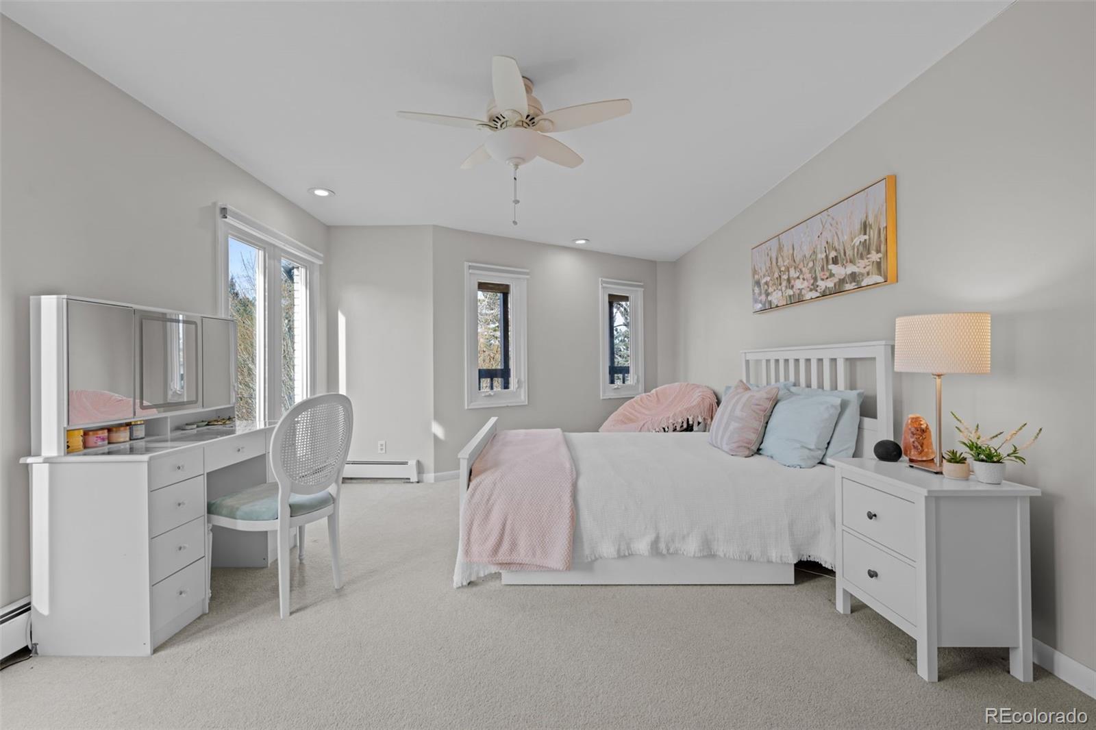 1 Rangeview Drive Wheat Ridge, CO 80215 - Photo 14 of 45 a spacious bedroom with a bed and a chandelier