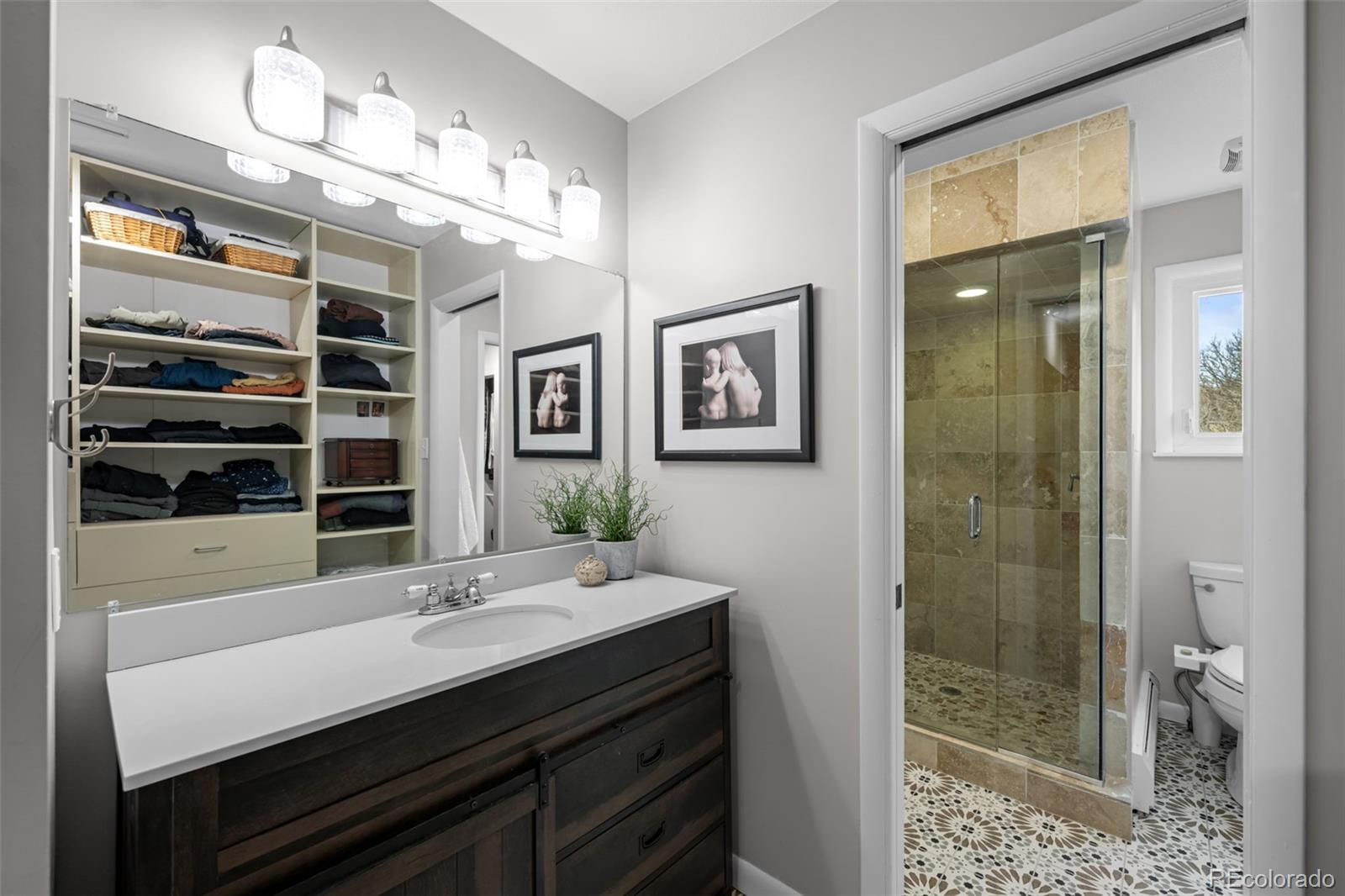 1 Rangeview Drive Wheat Ridge, CO 80215 - Photo 20 of 45 a bathroom with a sink a toilet and shower