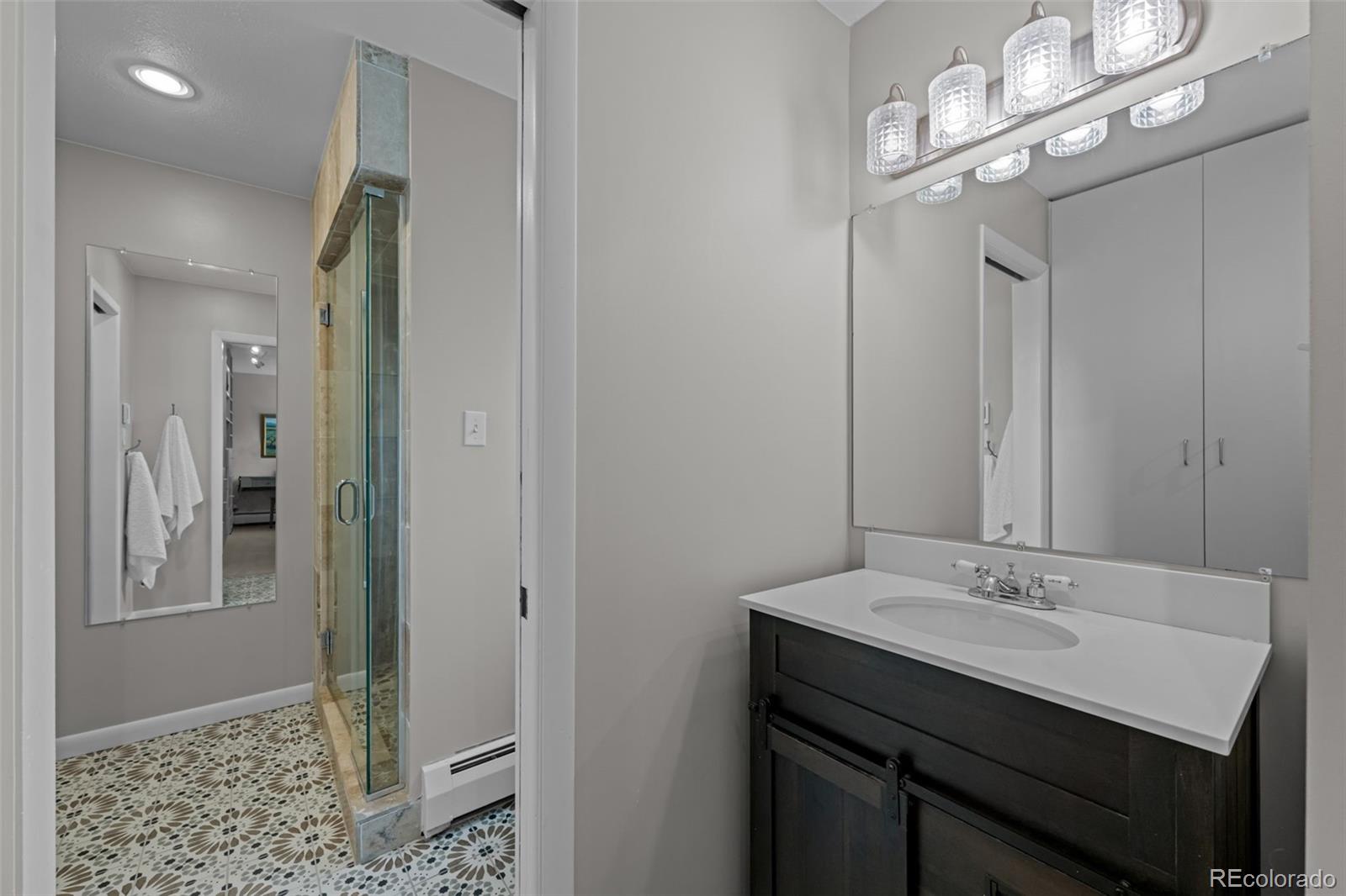1 Rangeview Drive Wheat Ridge, CO 80215 - Photo 22 of 45 a bathroom with a sink a light fixture and a mirror