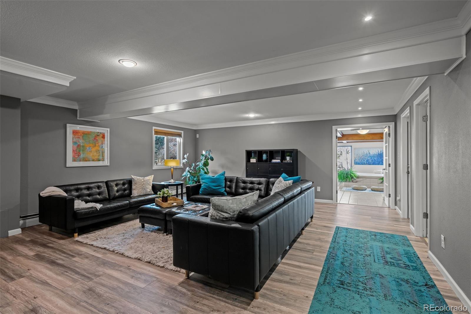 1 Rangeview Drive Wheat Ridge, CO 80215 - Photo 25 of 45 a living room with furniture and a flat screen tv
