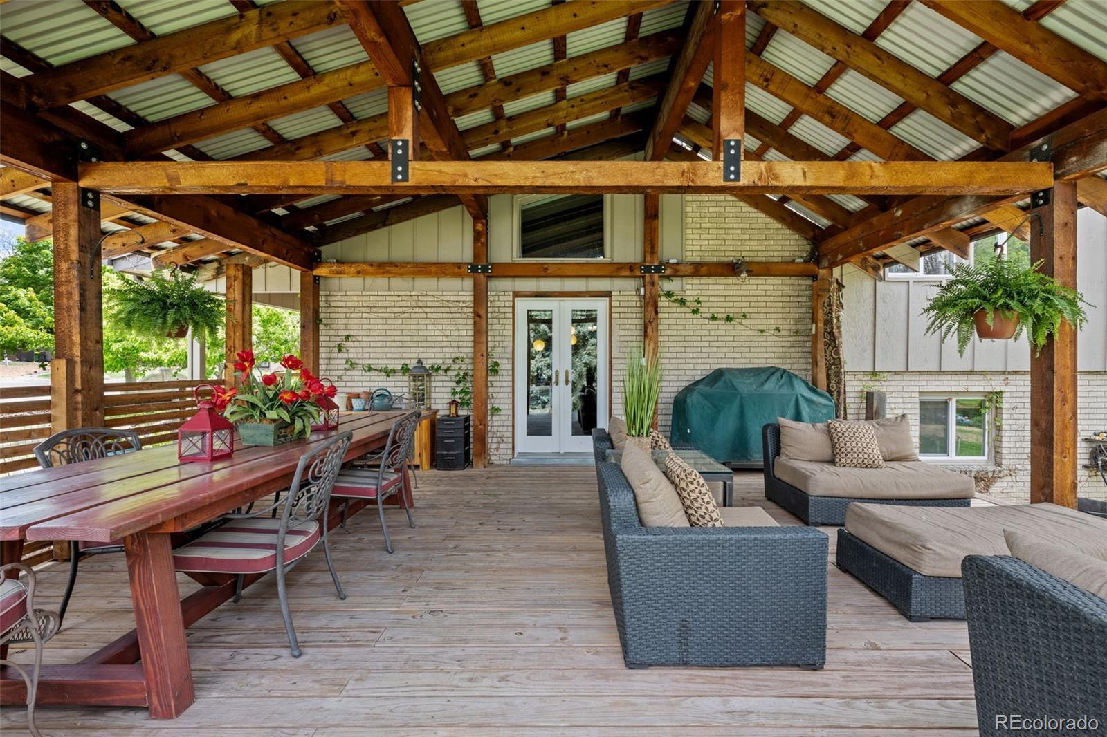 1 Rangeview Drive Wheat Ridge, CO 80215 - Photo 34 of 45 a living room with furniture a fireplace and a table