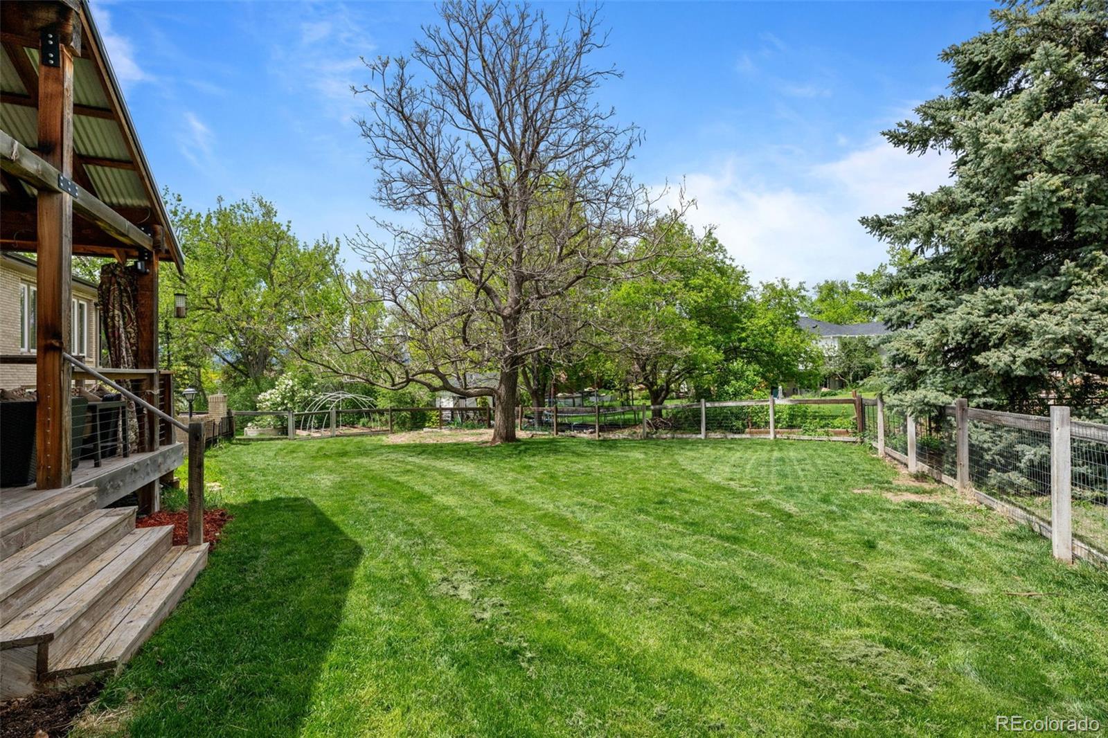 1 Rangeview Drive Wheat Ridge, CO 80215 - Photo 37 of 45 a view of a backyard with wooden fence and a large tree
