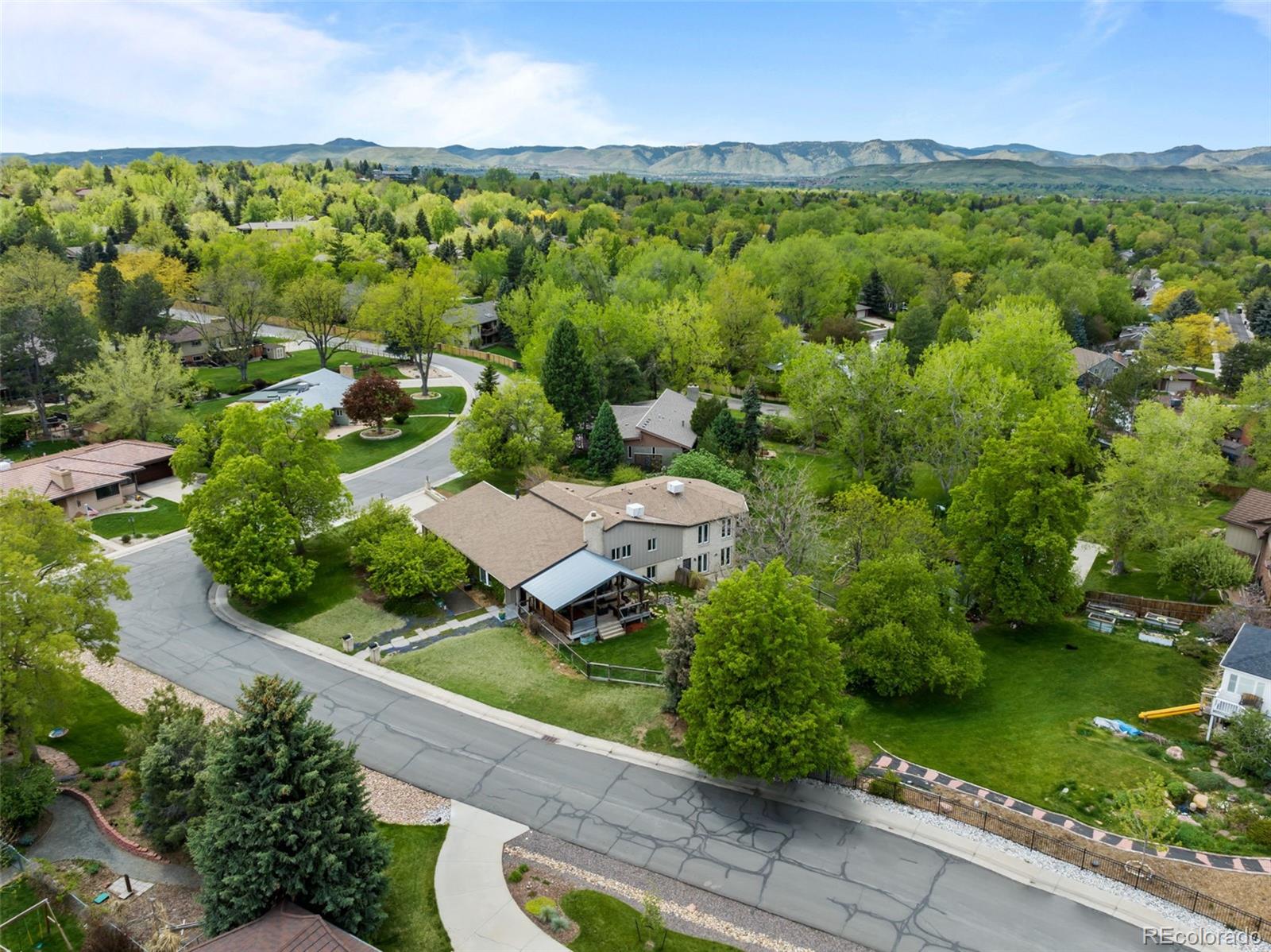 1 Rangeview Drive Wheat Ridge, CO 80215 - Photo 42 of 45 an aerial view of green landscape with trees houses and mountain view