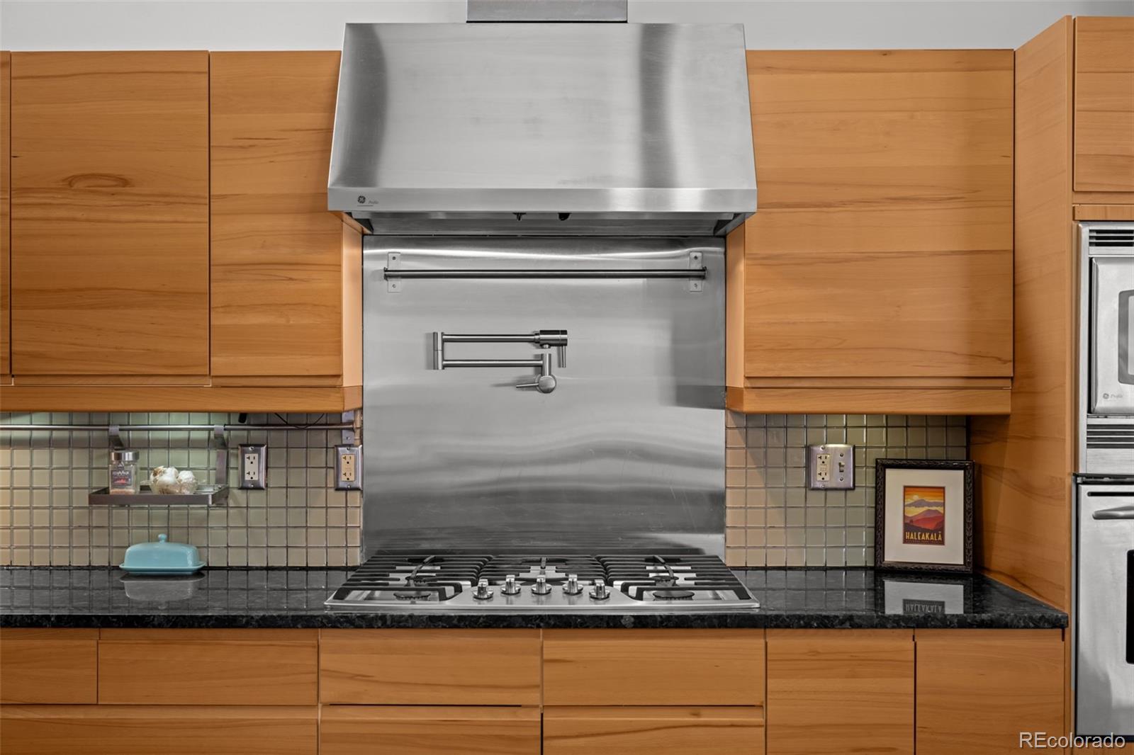 1 Rangeview Drive Wheat Ridge, CO 80215 - Photo 8 of 45 a bathroom with a granite countertop sink and a mirror