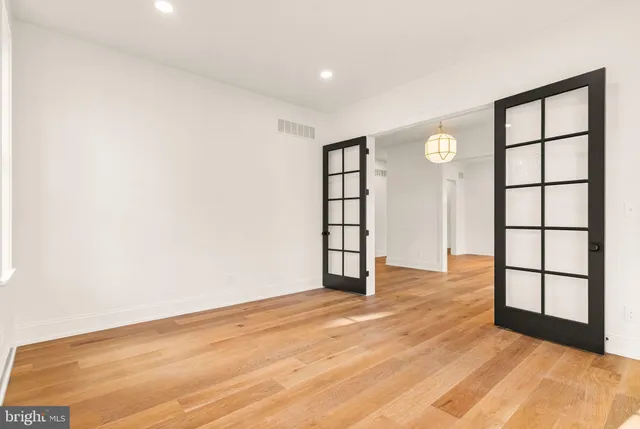 a kitchen with kitchen island a stove and a wooden floor