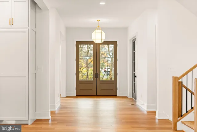 a view of empty room with wooden floor and fireplace