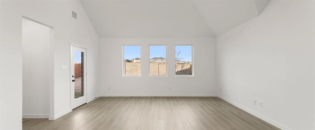 2306 Myrtle Way Melissa, TX 75454 - Photo 11 of 28 an empty room with wooden floor and window