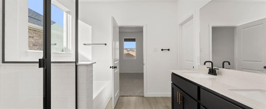 2306 Myrtle Way Melissa, TX 75454 - Photo 19 of 28 a bathroom with a double vanity sink a mirror and a shower