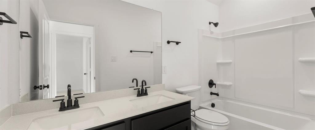 2306 Myrtle Way Melissa, TX 75454 - Photo 24 of 28 a bathroom with a sink a toilet and shower