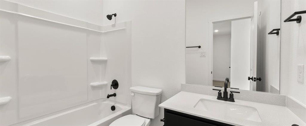 2306 Myrtle Way Melissa, TX 75454 - Photo 6 of 28 a bathroom with a sink a toilet and shower