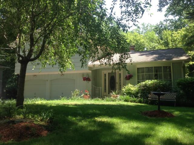 a view of a house with a yard and sitting area