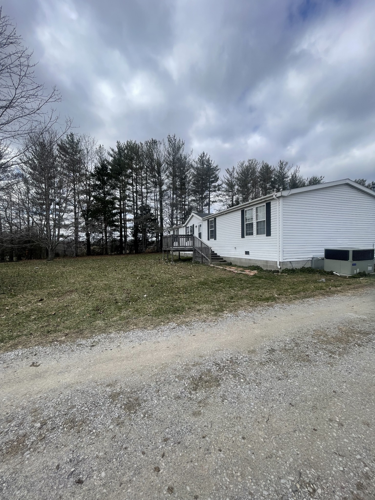 988 Womack Road McMinnville, TN 37110 - Photo 1 of 11 a view of a house with a big yard and a large tree
